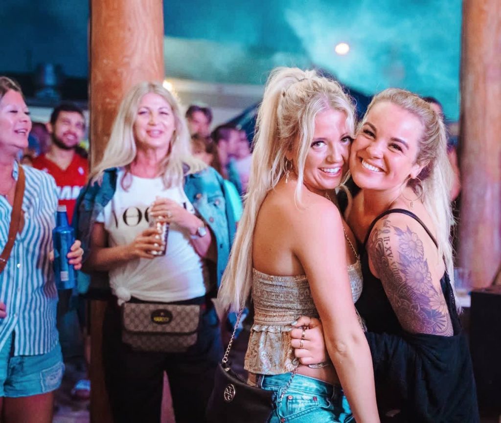two girls hugging at a concert