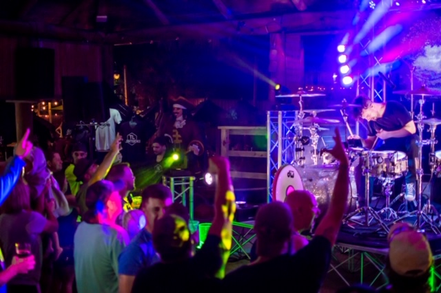 crowd at a concert in multi-colored lighting