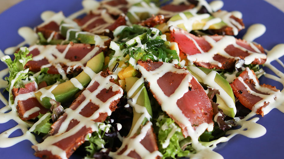 Bed of mixed greens, avocado, mango, seaweed salad & our seared sesame encrusted Ahi Tuna. Drizzled with our cucumber wasabi.